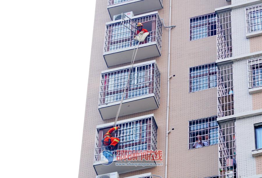 男子爬上飘窗顶部 消防队员通过半小时劝说将其成功解救