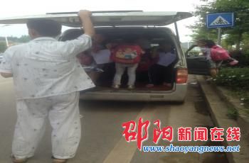 7座私家面包车成临时校车 学生站在后备箱后背紧贴车门