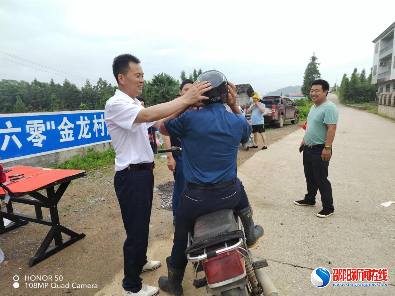 洞口县石江镇金龙村：宣传戴帽拆伞送头盔，看望高龄老人送粽子